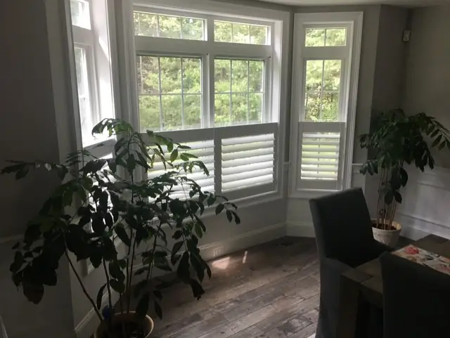 Café shutters on the bay windows of a dining nook