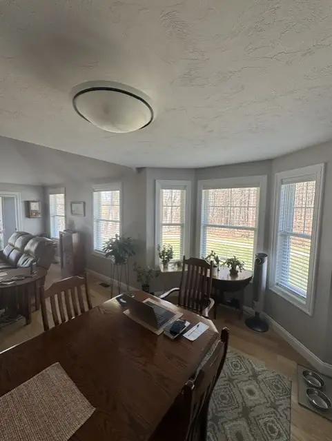 Dining room with light shades on a run of bay windows