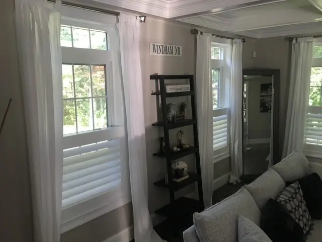 Lower-half shutters paired with sheer curtains in a living room