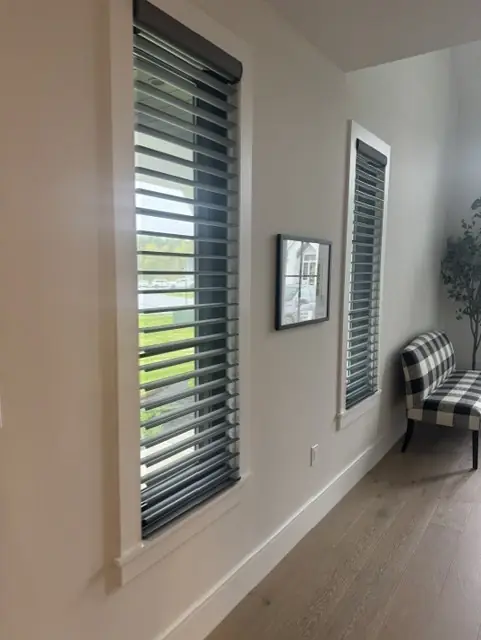 Sheer shadings with open vanes on tall, narrow living room windows
